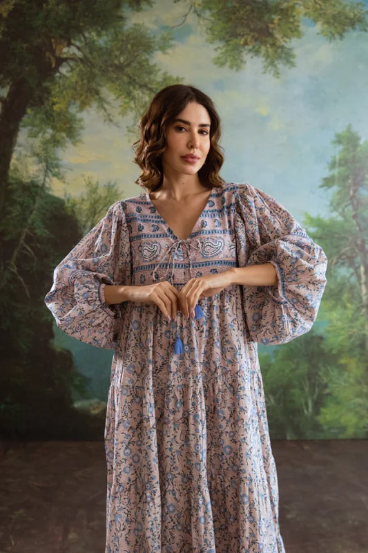 Woman wearing a floral dress with a scenic background